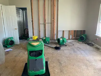Green air movers drying a gutted Bay Shore room